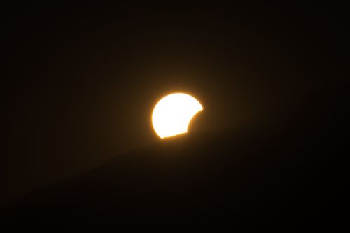 Free Capture of a partial solar eclipse over Poprad, Slovakia, illustrating celestial alignment. Stock Photo