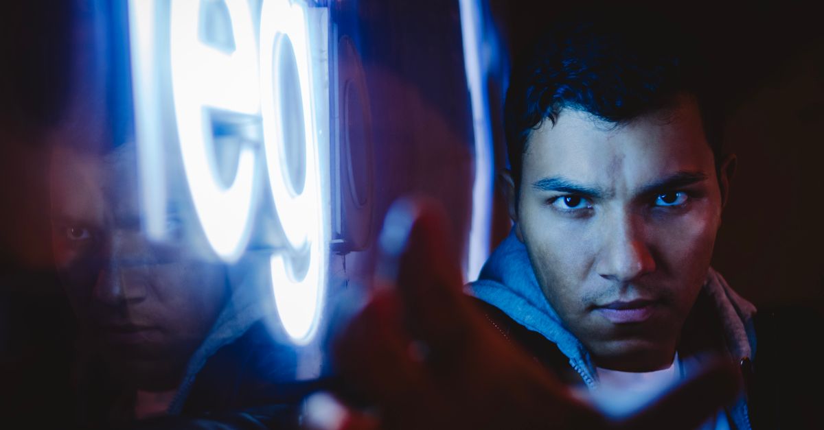 A person surrounded by streaming service icons on a glowing screen, looking overwhelmed but curious