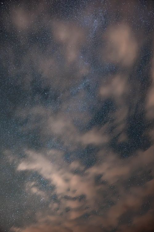 Free Capture of a starry night sky with clouds drifting over Rize, Türkiye. Perfect for celestial and nature themes. Stock Photo