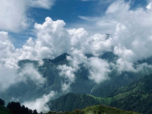 Free Stunning view of the Himalayan mountains with dramatic clouds and lush greenery. Stock Photo