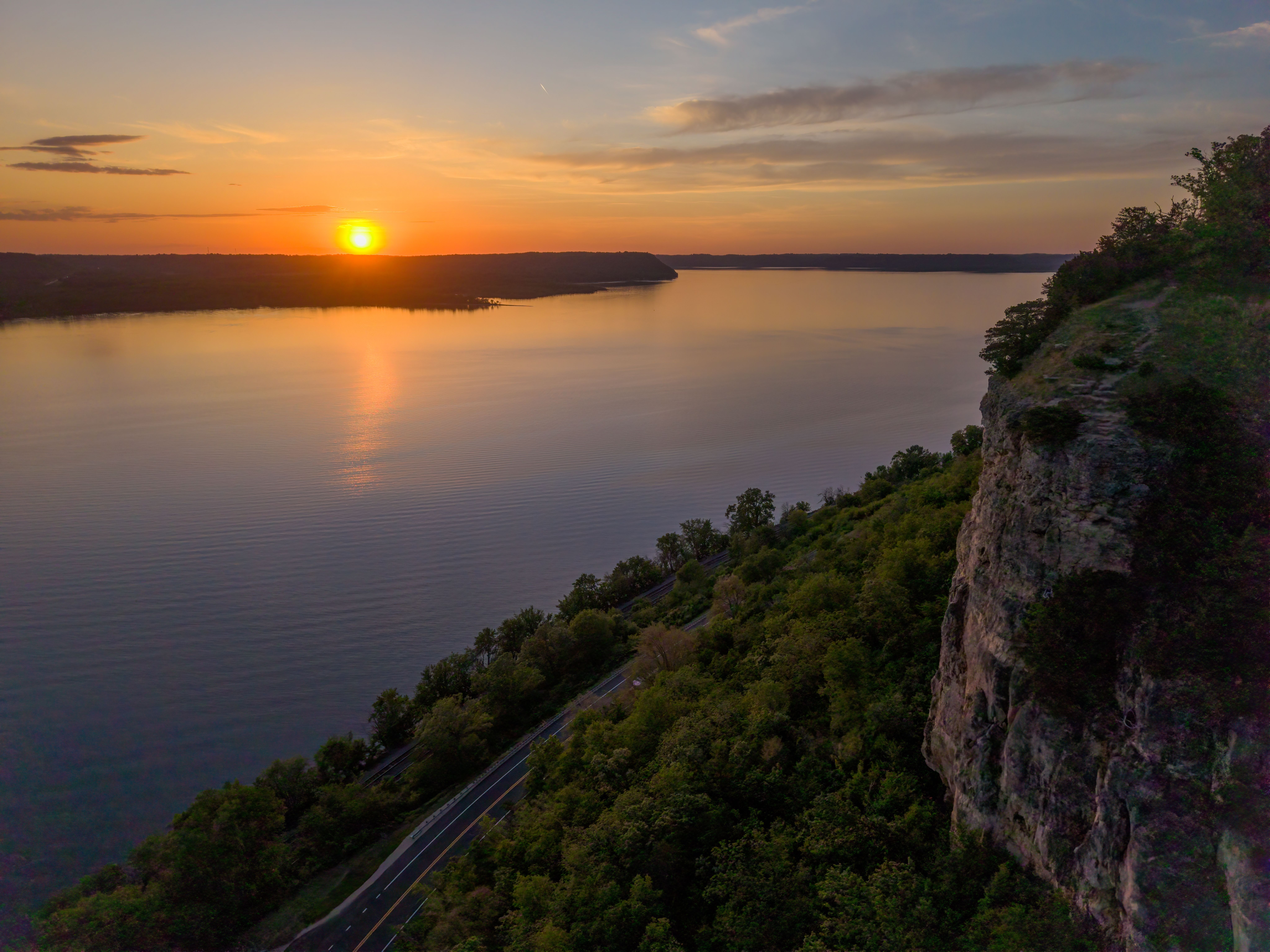A breathtaking sunset over a bluff near Lake Pepin in Maiden Rock, Wisconsin, highlighting natural beauty.