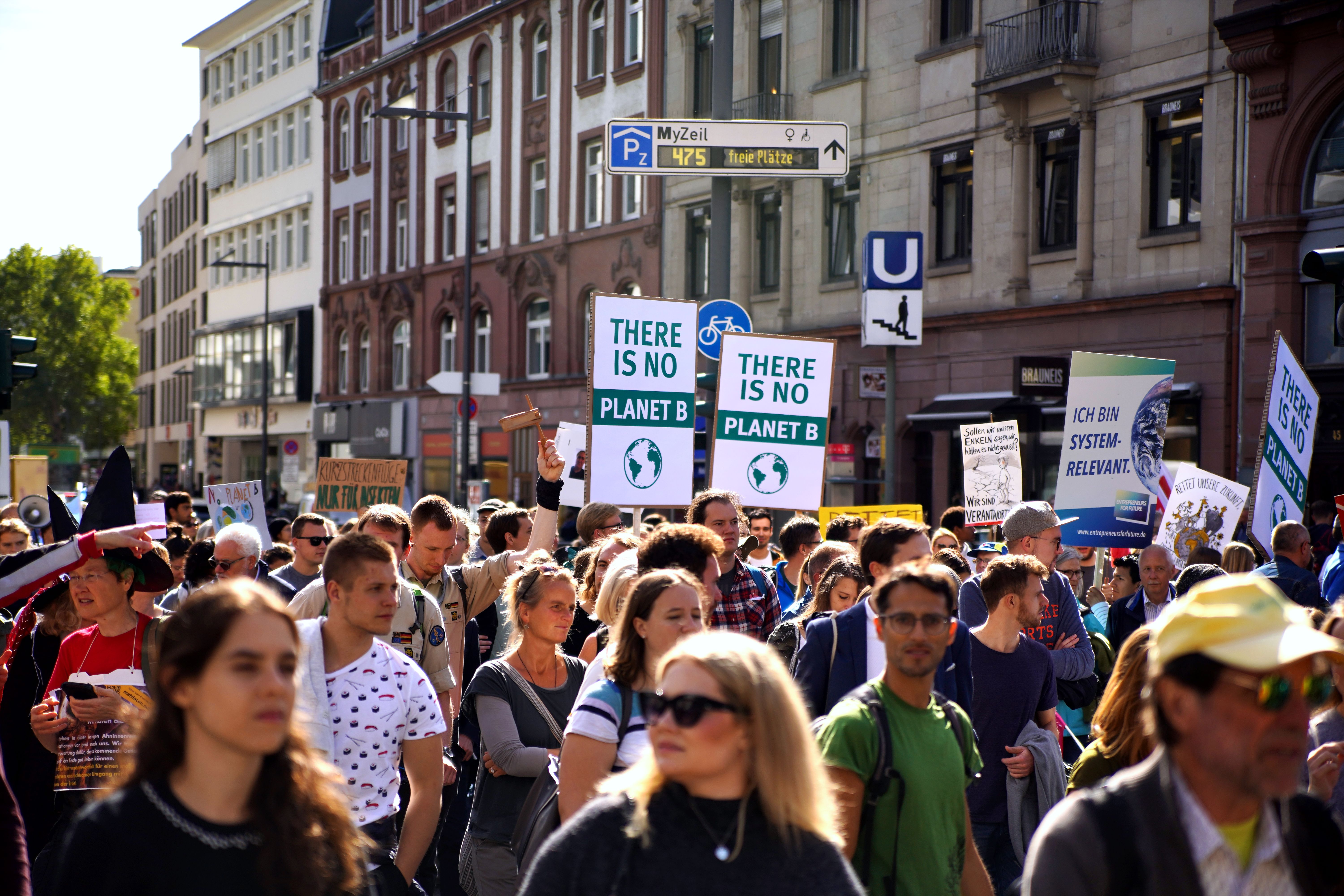 Crowd protesting climate change in Munich, holding signs like "There is no Planet B."