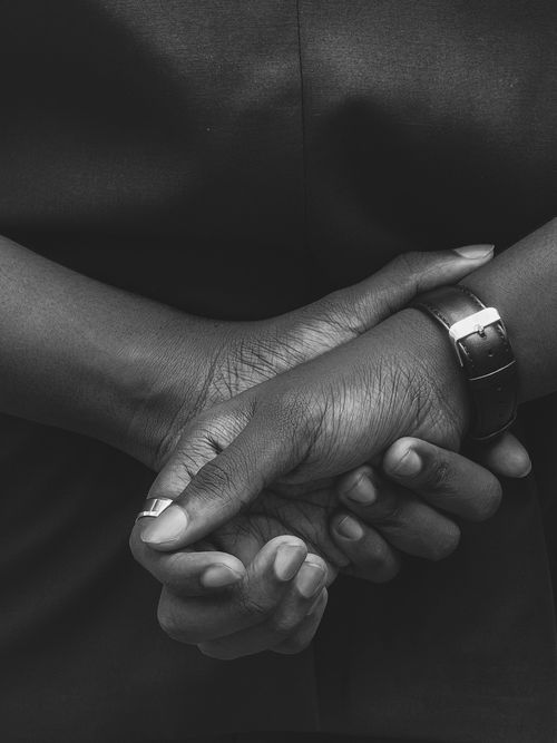 Free Monochrome photo of hands folded together, conveying unity and contemplation. Stock Photo