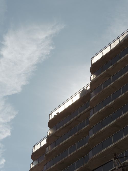 Free Urban architectural facade against a clear blue sky, capturing simplicity and modern design. Stock Photo
