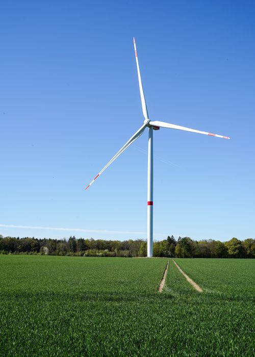 Free Scenic wind turbine in a green field in Hamwarde, Schleswig-Holstein. Stock Photo