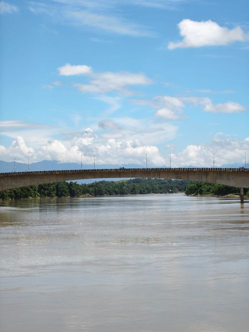 Free Beautiful view of Barak River with a striking bridge against a vibrant blue sky in Silchar, India. Stock Photo