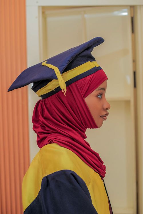 Free Profile of a young woman wearing a graduation cap and hijab indoors in Kaduna, Nigeria. Stock Photo