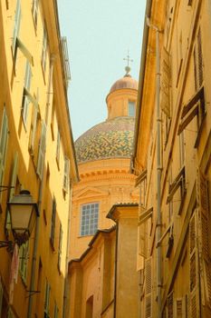 Vintage view of colorful architecture and dome in Nice, France, capturing the essence of its charming old town.