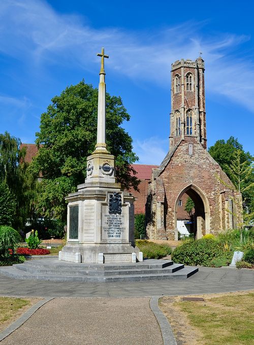 Free A historic monument and ancient tower in a peaceful park setting under a clear blue sky. Stock Photo