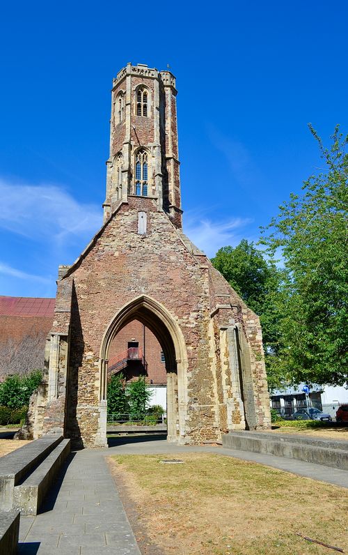 Free Explore the majestic ruins of an ancient Gothic church under a clear blue sky, surrounded by greenery. Stock Photo