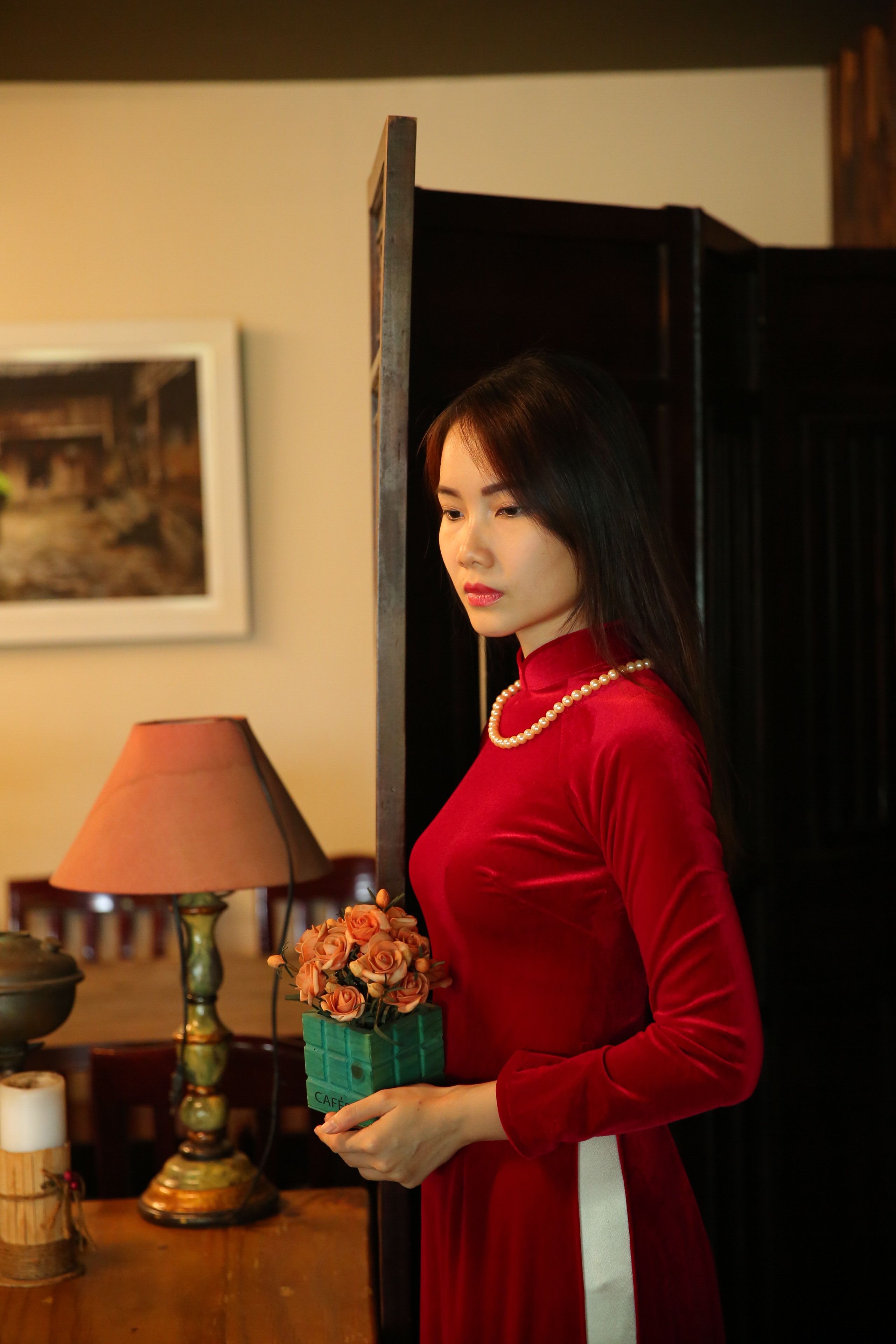 Woman In Red Long Sleeve Shirt Holding Flowers In A Vase · Free Stock Photo