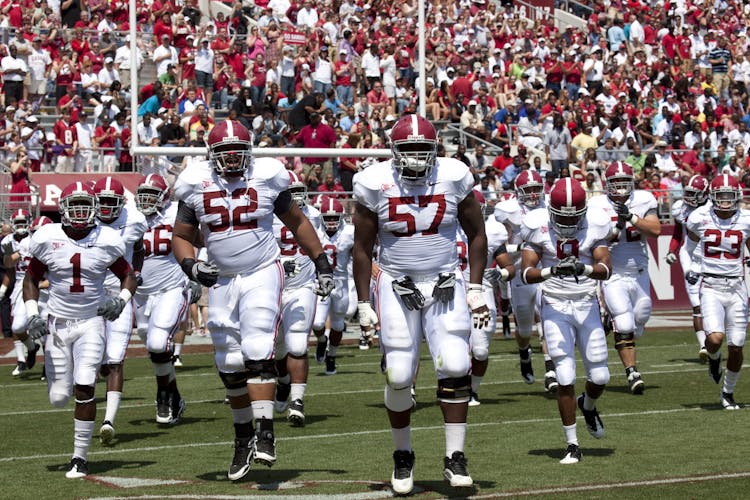 Football Players Wearing Jersey Outfits On Field