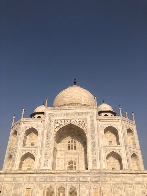 Free Captivating image of the iconic Taj Mahal under a clear blue sky, showcasing its architectural beauty. Stock Photo