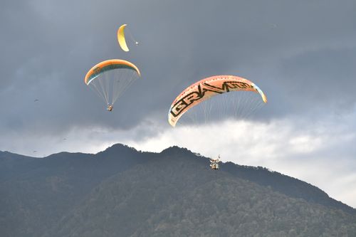 Free Experience the thrill of paragliding over scenic mountains in Bir, Himachal Pradesh, India. Stock Photo