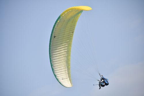 Free Experience the thrill of paragliding over the scenic landscapes of Bir, Himachal Pradesh, India. Stock Photo