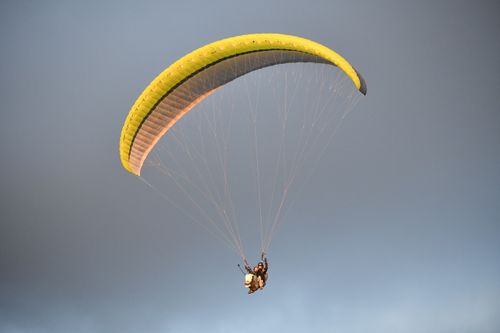 Free Experience thrilling paragliding over Bir, Himachal Pradesh, with exhilarating open skies. Stock Photo