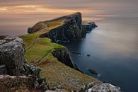 Green and Brown Mountain Cliffs Near Ocean
