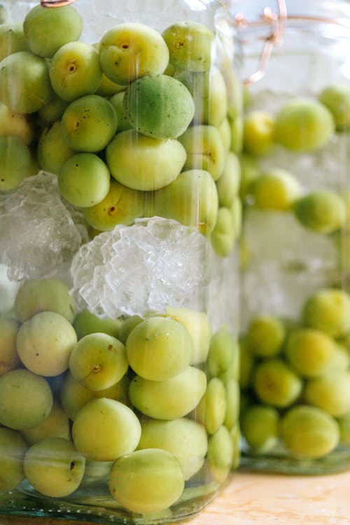 Free Glass jar with fresh green olives and ice Stock Photo