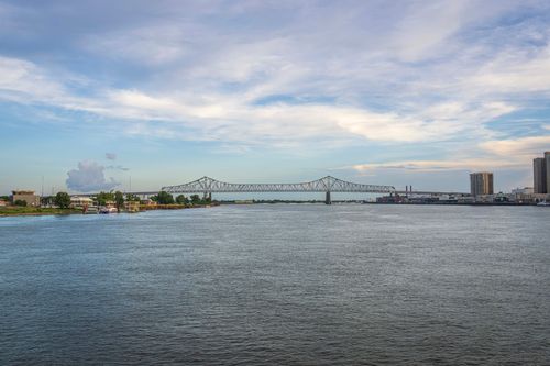 Free Calm view of bridge over Mississippi River with cityscape and blue sky in the background. Stock Photo