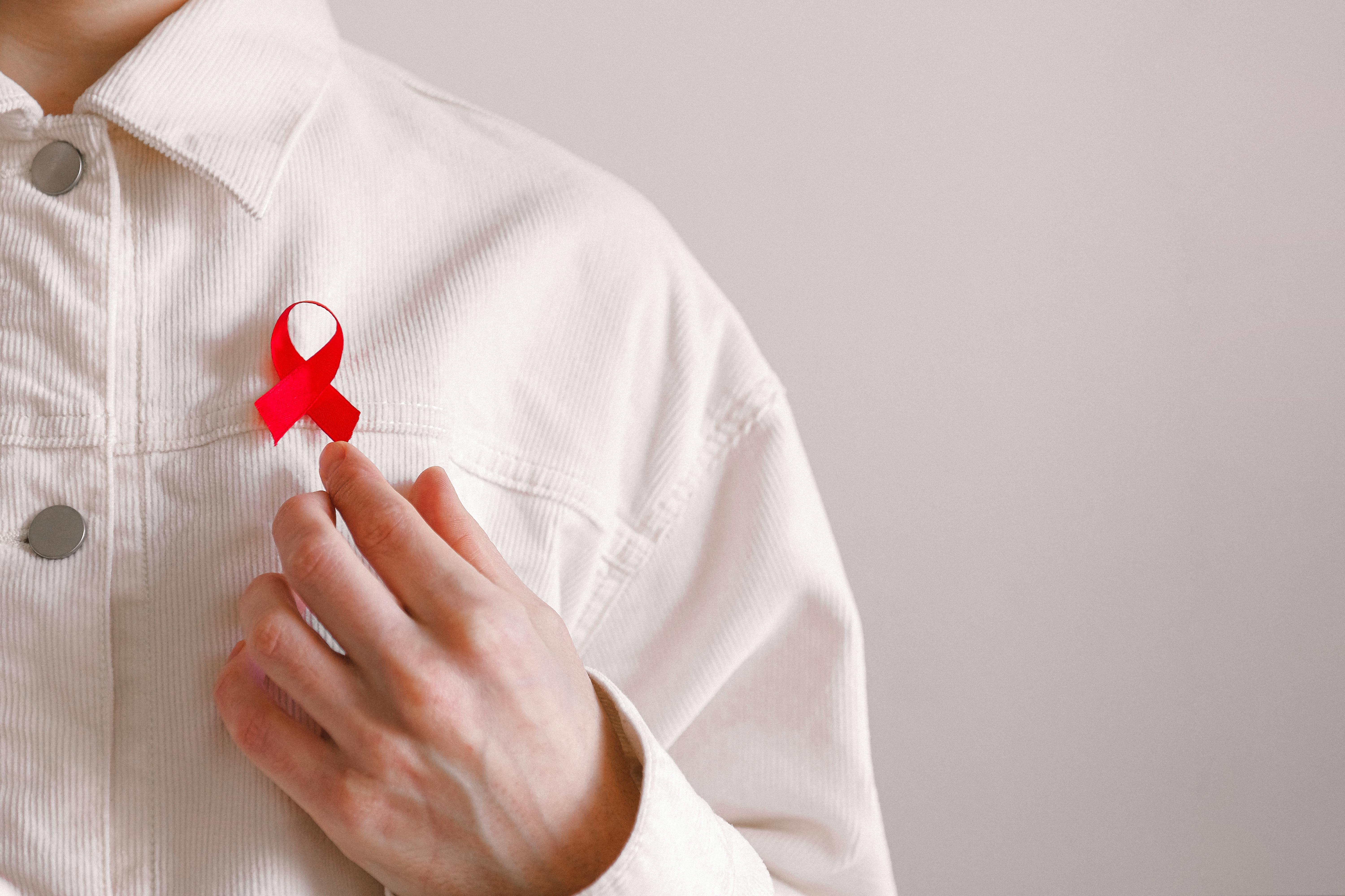 man wearing red ribbon