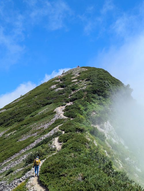 Free A thrilling hike on a mountain trail in Hakuba, Nagano, Japan under clear blue skies. Stock Photo