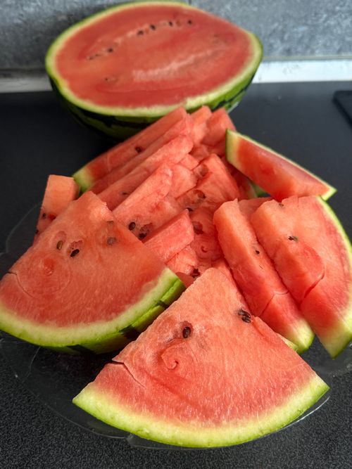 Free Vibrant and juicy watermelon slices arranged on a plate for a refreshing summer treat. Stock Photo