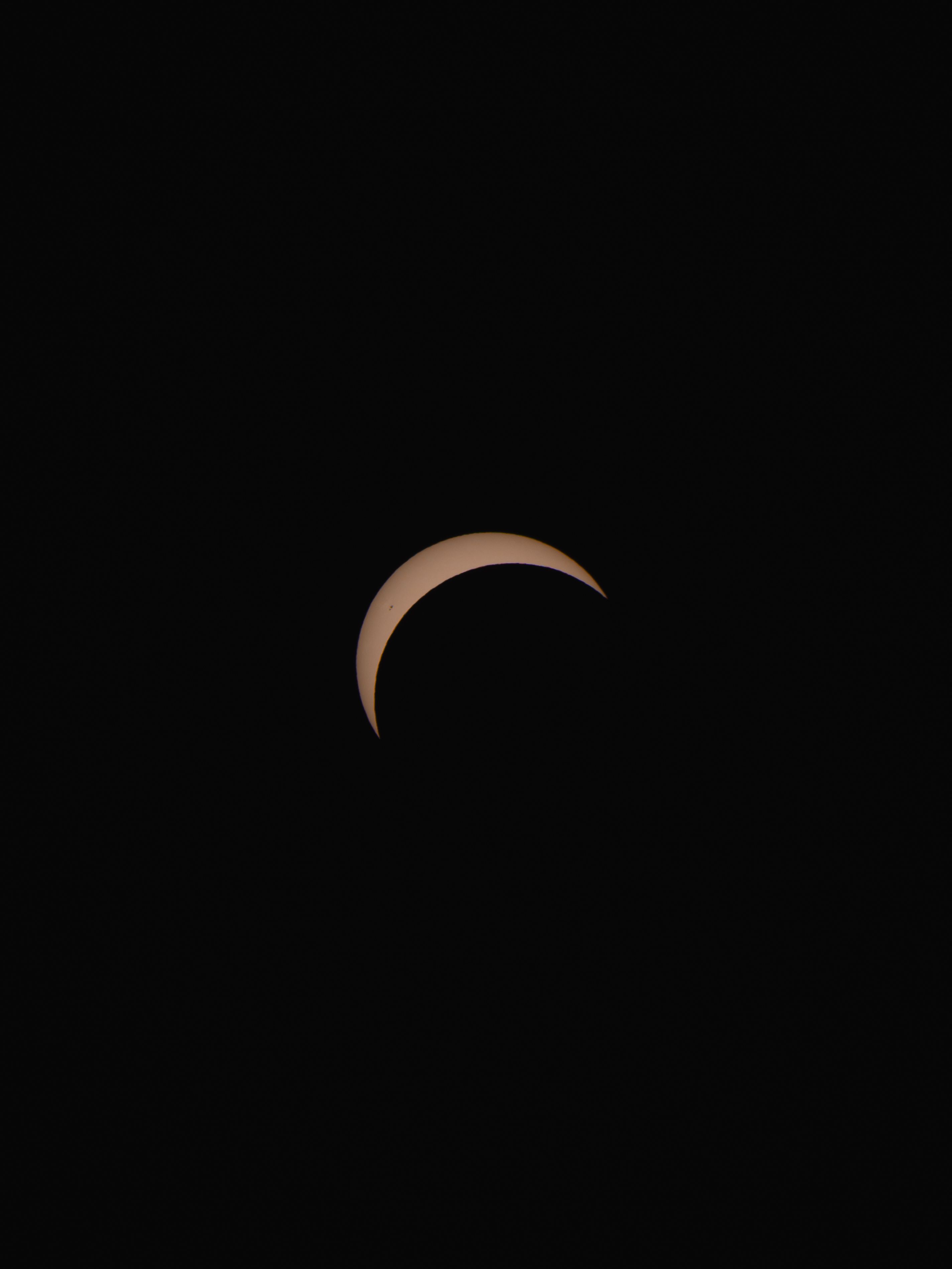 Stunning view of a crescent solar eclipse captured at night in Germany.