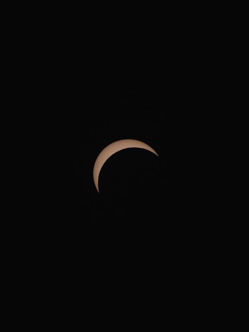 Stunning view of a crescent solar eclipse captured at night in Germany.