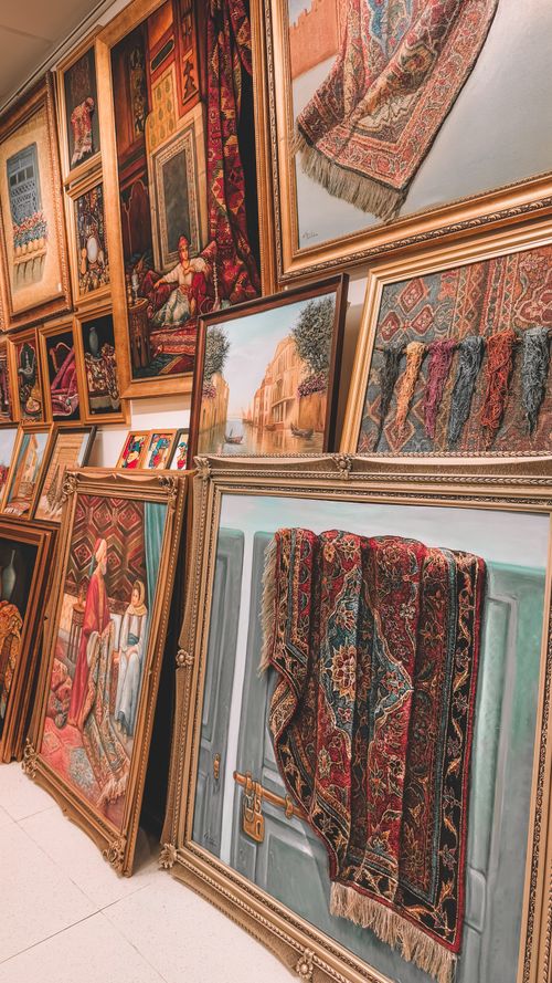 Free A vibrant showcase of Persian-style carpets and paintings in a Dubai art gallery. Stock Photo