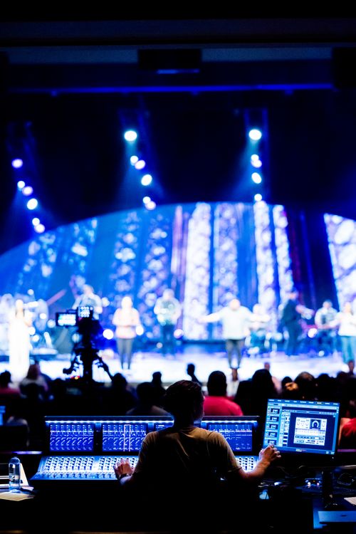 Free Sound engineer at a live concert, vibrant stage lighting, musical performance. Stock Photo