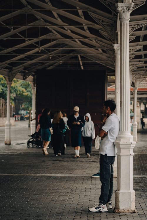 Free Diverse individuals at a historic train station in Bilbao, Spain. Stock Photo