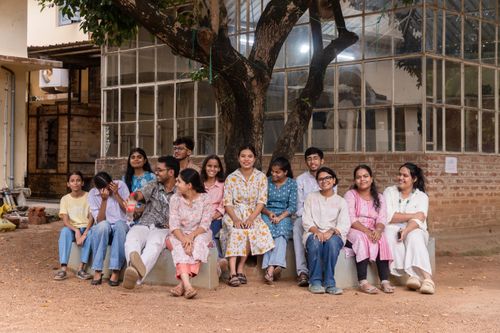 Free A diverse group of students enjoys a casual gathering under a tree at Visva Bharati campus in Santiniketan. Stock Photo
