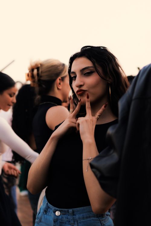 Free A group of stylish young adults socializing at a vibrant outdoor party in Cairo, Egypt. Stock Photo
