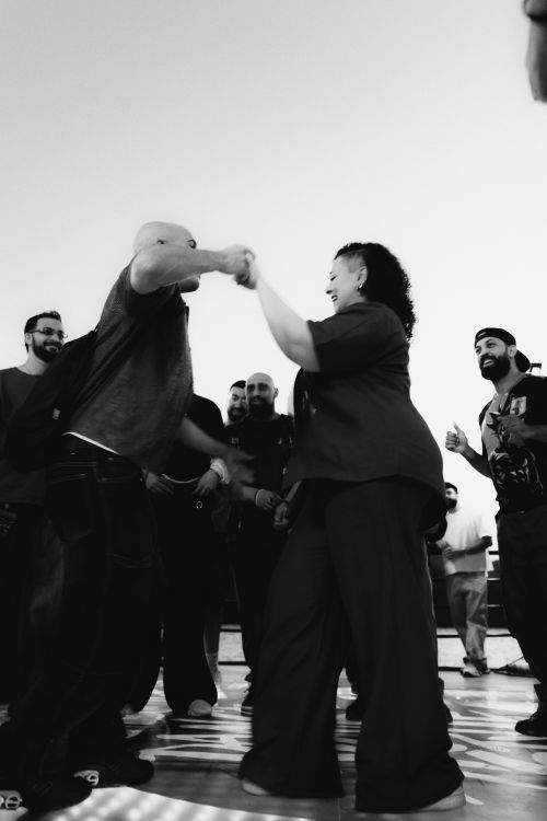 Free A group of adults enjoying a street dance meetup in Cairo. Urban vibe and energy. Stock Photo