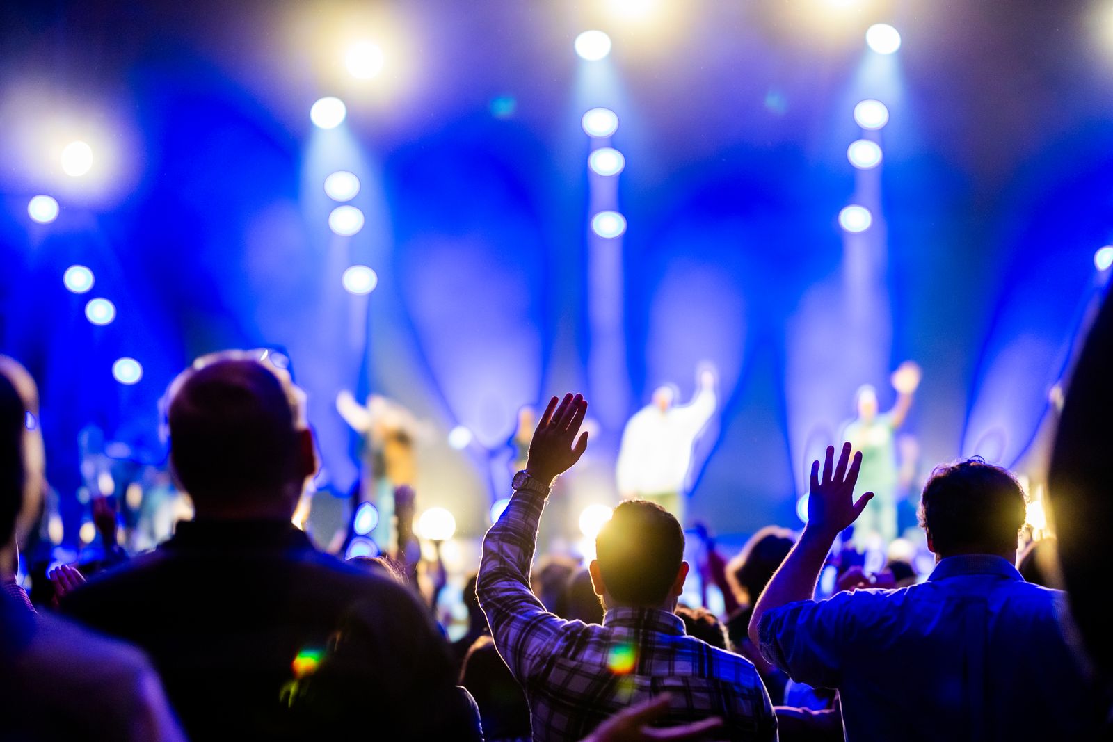 Crowd under blue stage lights at a festival