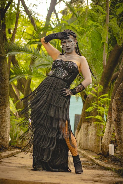 Free Artistic gothic cosplay with striking makeup in a lush outdoor setting, merging fantasy with nature. Stock Photo
