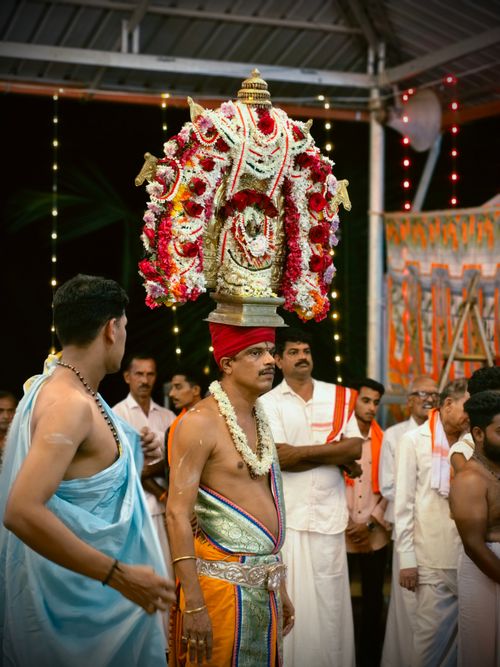 Free Men participating in a traditional Bhoota Kola ceremony in Karnataka, India, with vibrant attire and deity decoration. Stock Photo