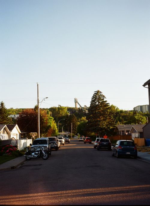 Free Charming street scene during golden hour with visible ski jump in Calgary, Alberta. Stock Photo