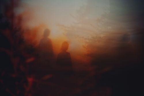 Free Ethereal silhouettes with a warm, abstract sunset background creating a dreamy atmosphere. Stock Photo