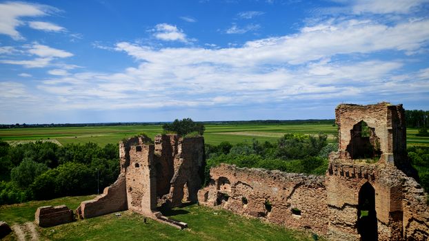 Explore the historic Bač Fortress ruins under a vibrant blue sky in Vojvodina, Serbia.
