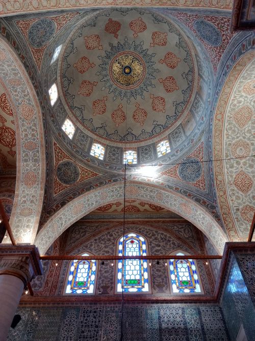 Free Explore the intricate designs of a historical mosque's ceiling with ornate mosaics and stained glass windows. Stock Photo