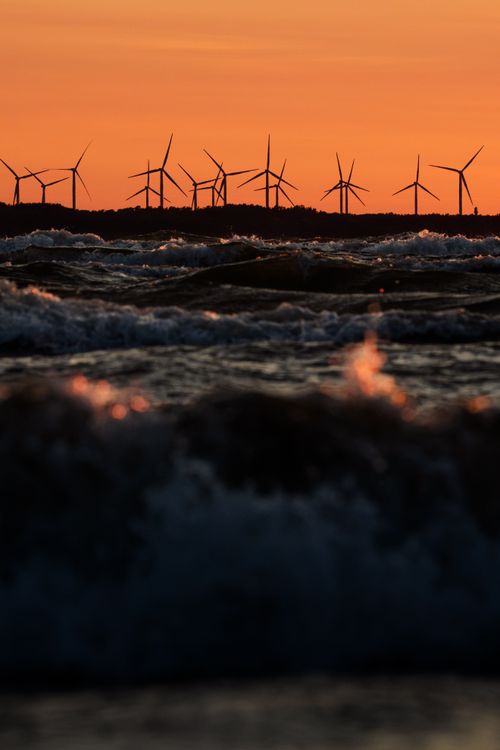 Free Captivating sunset over Baltic Sea at Kloogaranna, Estonia, with silhouetted wind turbines. Perfect for eco-themed visuals. Stock Photo