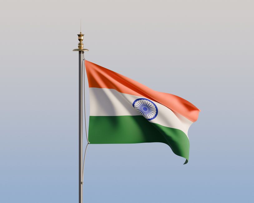 The Indian flag waving proudly against a clear sky, symbolizing national pride and heritage.