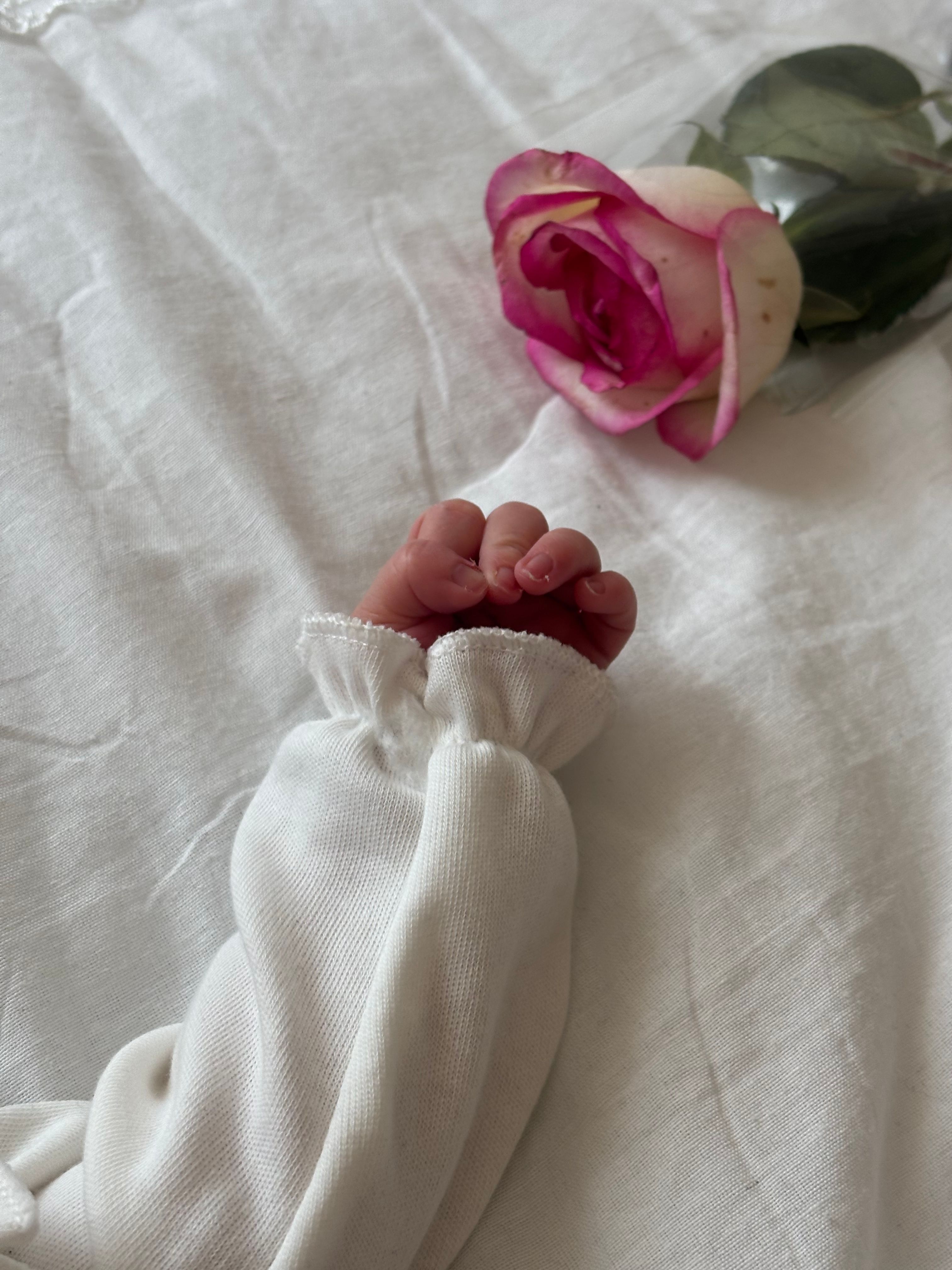 Flowers beside a newborn care kit