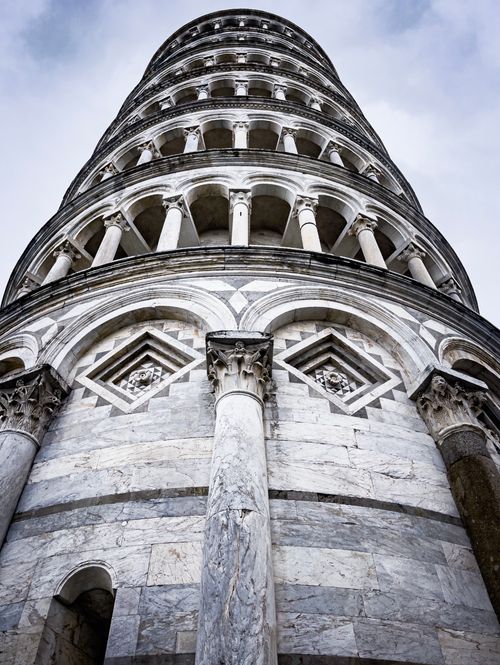 Free Upward view of the historic Leaning Tower of Pisa showcasing its unique architectural design. Stock Photo