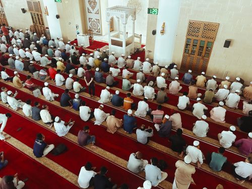 Free Aerial view of a diverse group of men gathered for prayer in a mosque. Stock Photo
