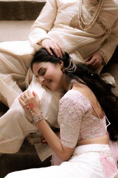 A joyful moment captured during an Indian wedding, highlighting traditional attire and happiness.