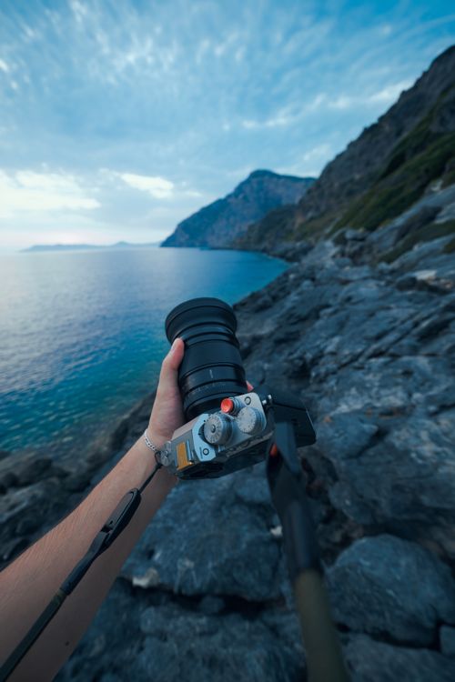 Free Capturing a scenic view of rocky coastal landscape with a camera at dusk. Stock Photo