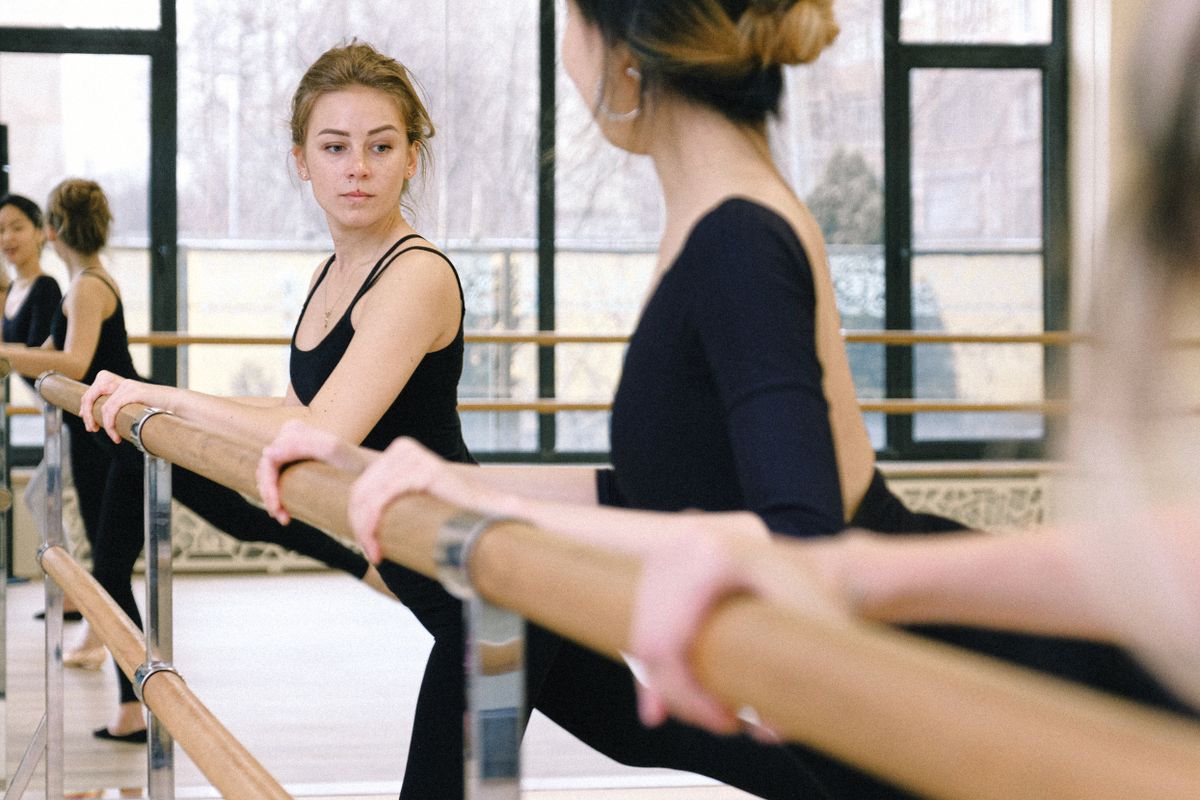 Members mid-class in a mirrored studio — photo by Anna Shvets on Pexels