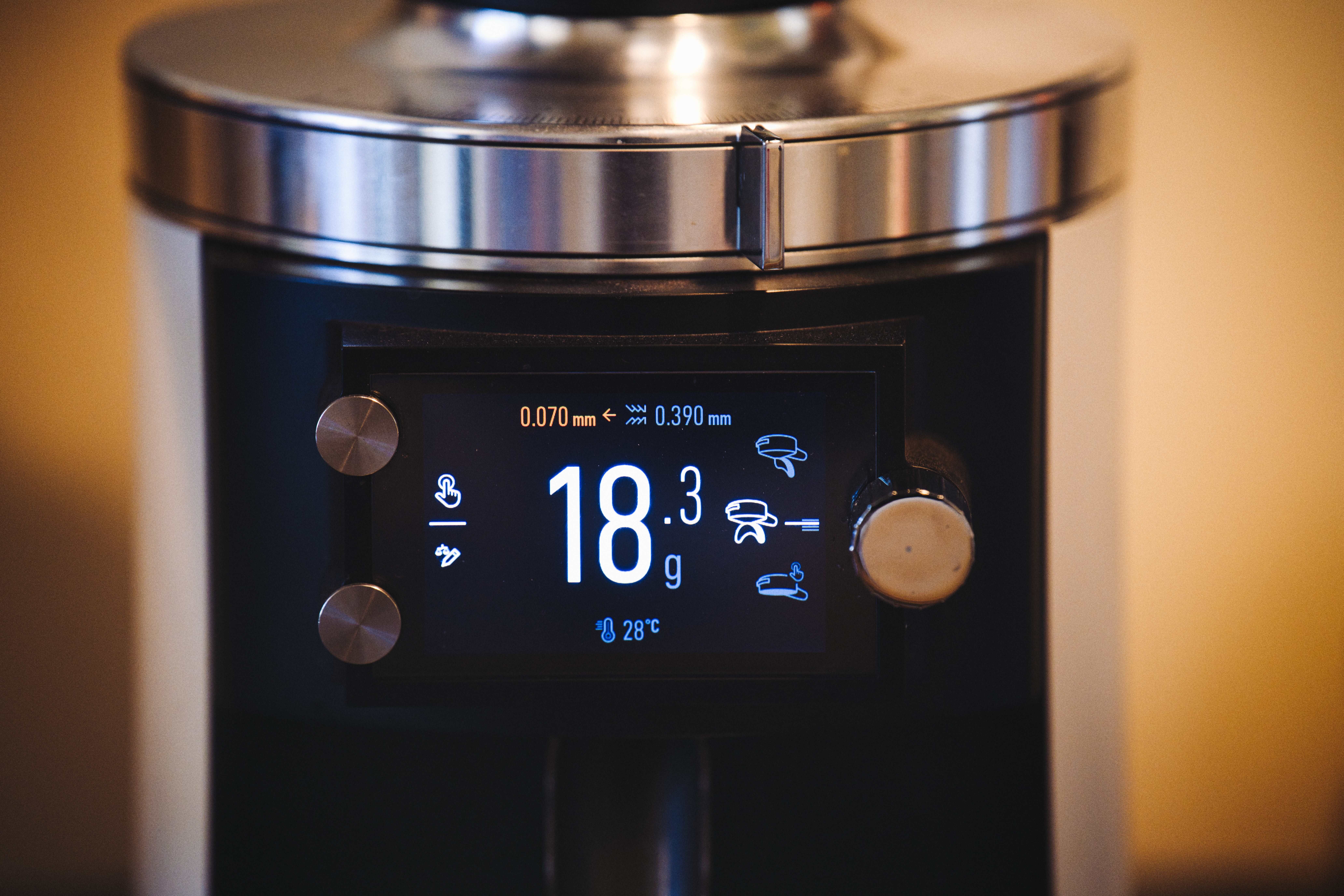 A modern coffee grinder with digital display showing measurements, ideal for baristas.